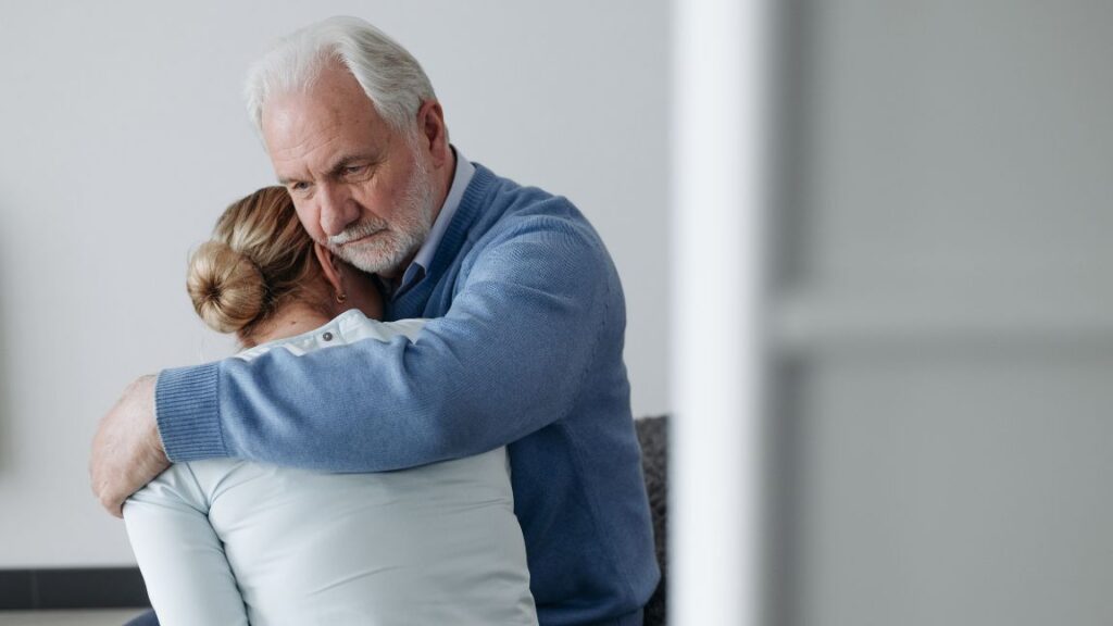 Senior man comforting a sad woman