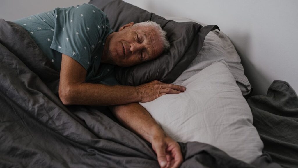 Senior man sleeping on his bed