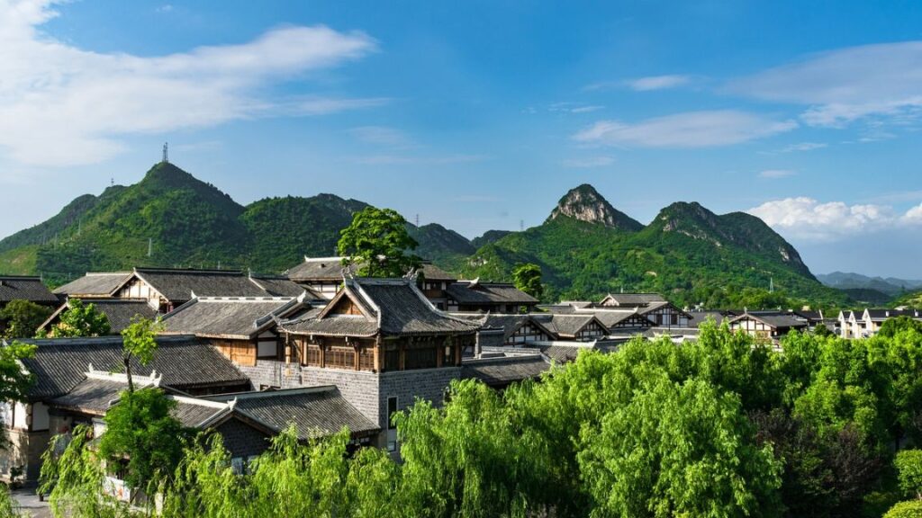 Chinese traditional buildings with mountains in the background